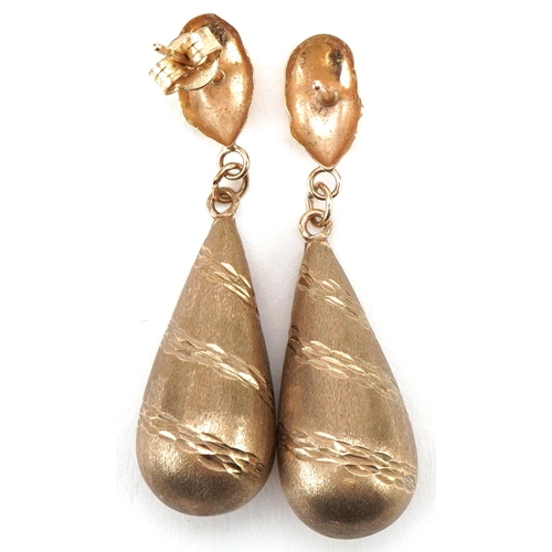 3474 - Pair of yellow metal engine turned teardrop earrings, each 3.5cm high, total 1.5g