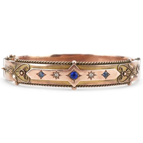 Edwardian 9ct rose gold blue stone and diamond hinged bangle, Birmingham 1906,  6.8cm wide, 15.0g