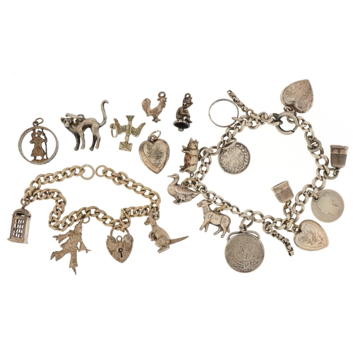 3213 - Two silver charm bracelets with a large collection of mostly silver charms, total 66.7g