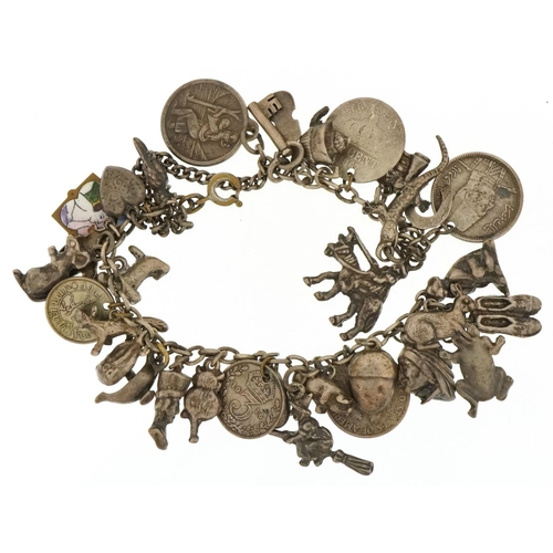 3352 - Large collection of vintage and later silver and white metal charms arranged on a white metal chain ... 