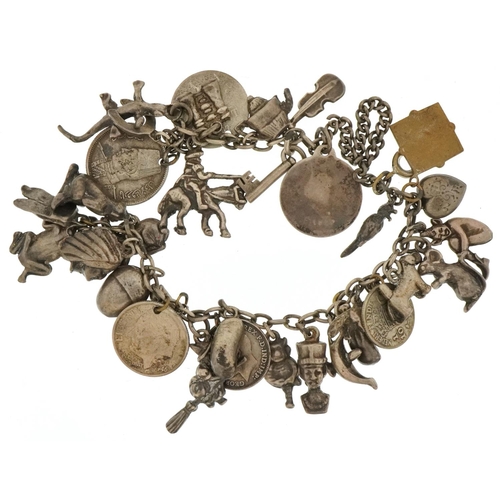 3352 - Large collection of vintage and later silver and white metal charms arranged on a white metal chain ... 