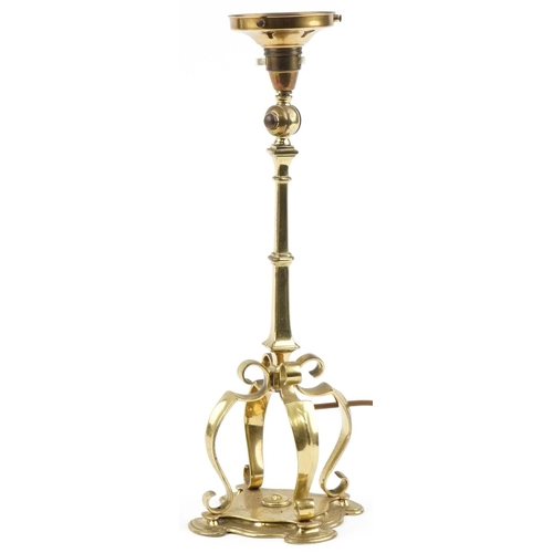 73 - Arts & Crafts brass lamp with stylized base, 43cm high