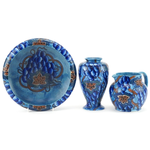 300 - Charlotte Rhead for Bursley Ware Blue Grape design footed bowl, vase and jug numbered 585 to the bas... 