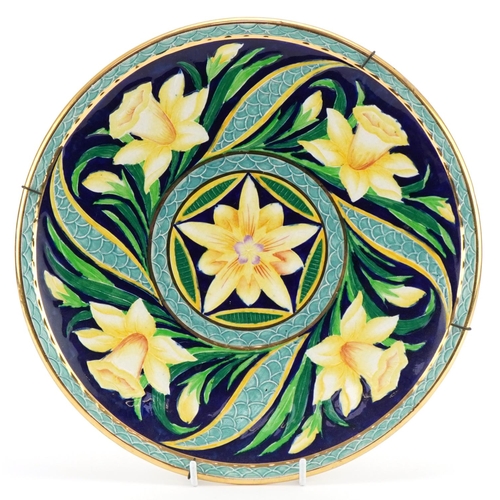 386 - Newhall stylized pottery charger decorated with daffodils, 30cm in diameter