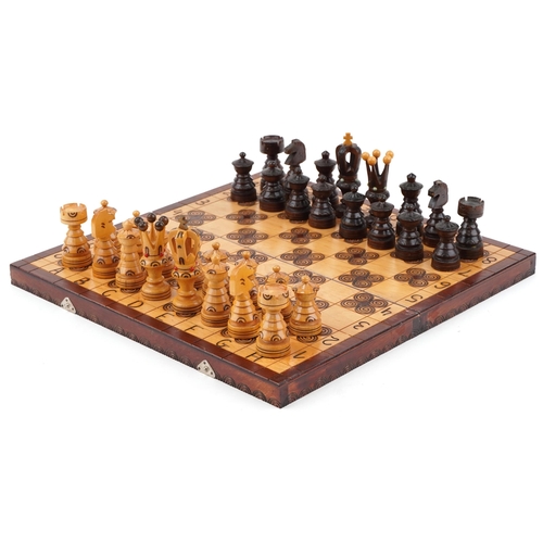 2325 - Drzewiarz carved wooden chess set and folding board, the largest piece 9.5cm high, the board 44.5cm ... 