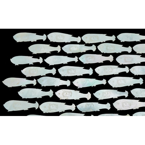 1213 - Eighty four mother of pearl fish counters, each 6cm in diameter