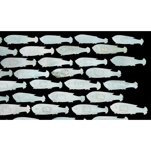 1213 - Eighty four mother of pearl fish counters, each 6cm in diameter