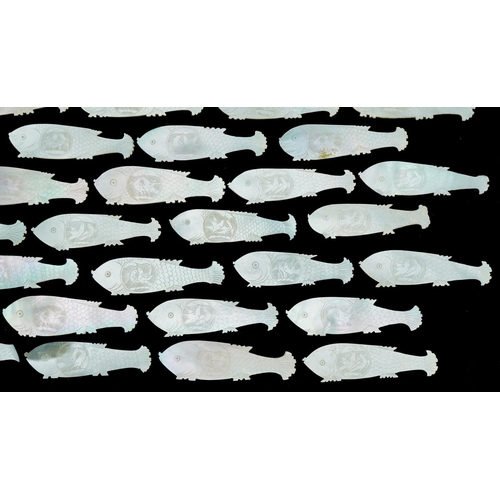 1213 - Eighty four mother of pearl fish counters, each 6cm in diameter