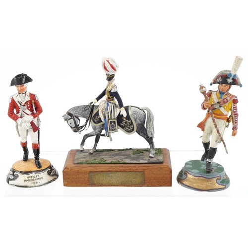 2319 - Seven hand painted model metal soldiers, some with wooden plinth bases, the largest 14cm high