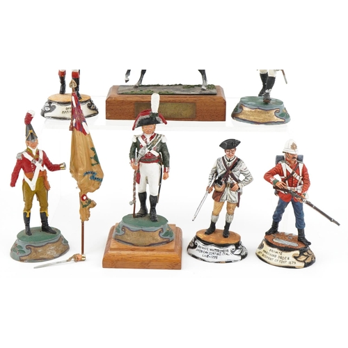 2319 - Seven hand painted model metal soldiers, some with wooden plinth bases, the largest 14cm high