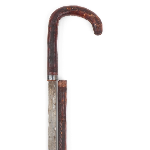 1032 - Antique leather covered swordstick with steel blade, possibly bamboo, 82cm in length