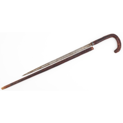 1032 - Antique leather covered swordstick with steel blade, possibly bamboo, 82cm in length