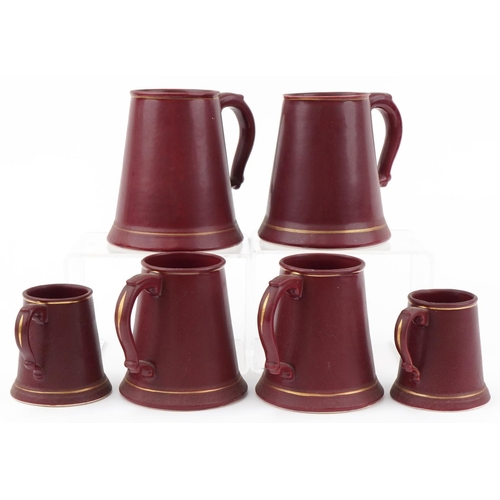 2145 - Six Whitbread burgundy glazed tankards, some by Bretby and Harry E Tunnicliffe Ltd, the largest 19cm... 