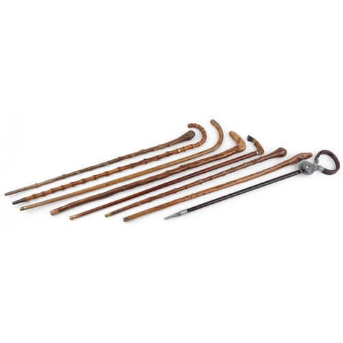 2216 - Collection of vintage walking sticks one with horn handle a bamboo example, and a shooting stick, th... 