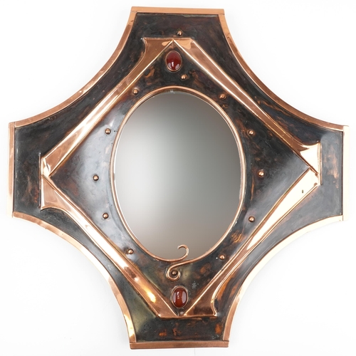 402 - Sam Fanaroff stylized copper mirror inset with red stone cabochons, 68cm x 67cm