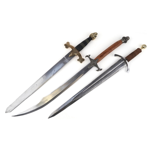 2614 - Three decorative model swords, the largest 100cm in length