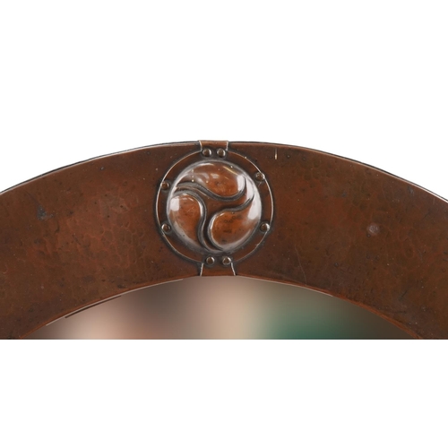 41 - Liberty's Arts & Crafts oval copper mirror, Liberty London label to the reverse, 62cm wide