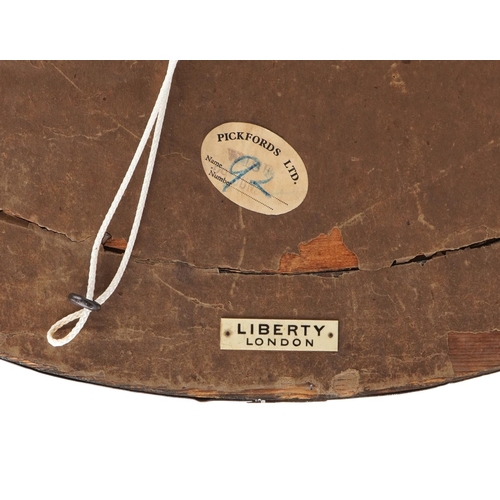 41 - Liberty's Arts & Crafts oval copper mirror, Liberty London label to the reverse, 62cm wide