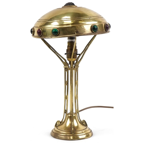 492 - WMF style brass table lamp, the shade set with colourful cabochon glass stones, 37cm high