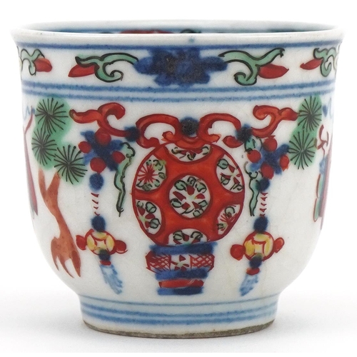 1202 - Miniature Chinese cup hand painted with objects and figures, character mark to the base, 4cm high