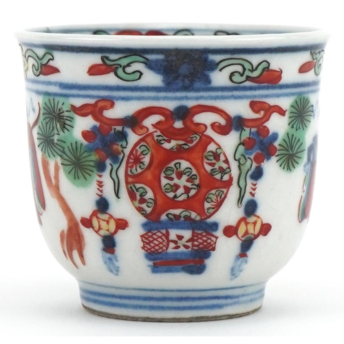 1202 - Miniature Chinese cup hand painted with objects and figures, character mark to the base, 4cm high