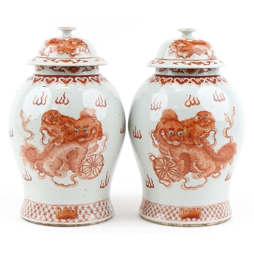 1104 - Large pair of Chinese porcelain baluster vases with covers, each hand painted in iron red with dogs ... 