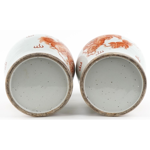 1104 - Large pair of Chinese porcelain baluster vases with covers, each hand painted in iron red with dogs ... 