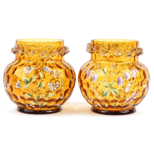 1278 - Pair of amber and clear glass vases hand enamelled with daisies and harebells, each 15cm high