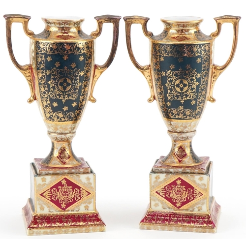 1250 - Pair of Vienna porcelain urns decorated with maidens and cherubs, marked to the base, 23cm high