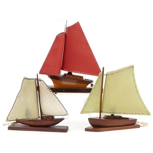 2162 - Three teak model boat table lamps with sails, possibly Scandinavian, the largest 50cm in length