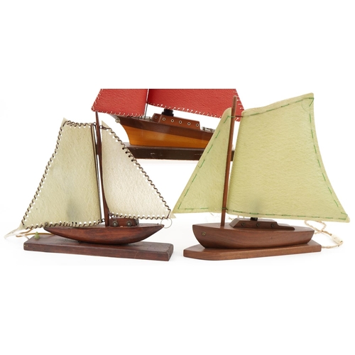 2162 - Three teak model boat table lamps with sails, possibly Scandinavian, the largest 50cm in length