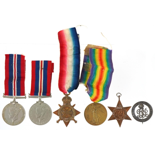 2528 - British military medals and cap badge including World War I pair awarded to 93839 GNR.E.ELLIS.R.F.A