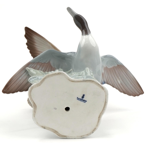 2099 - Lladro porcelain group of two ducks in flight, 31cm high