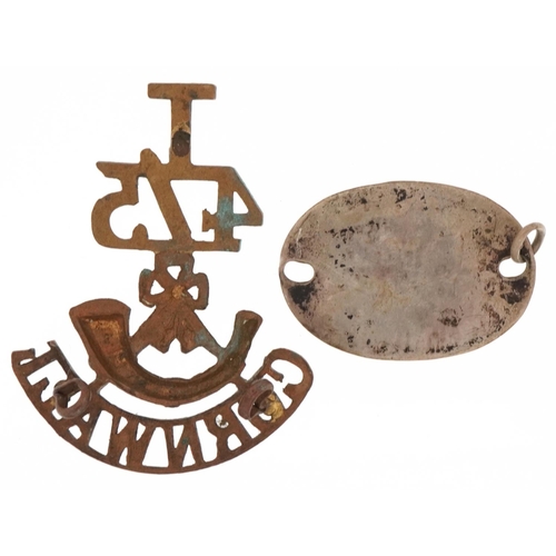 2538 - Military interest dog tag for J Mansfield 34154 3FLD.AMV and a brass Cornwall regiment badge, the la... 