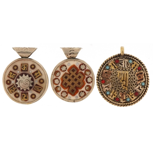 1331 - Three Middle Eastern pendants, one set with semi precious stones, the largest 4cm in diameter