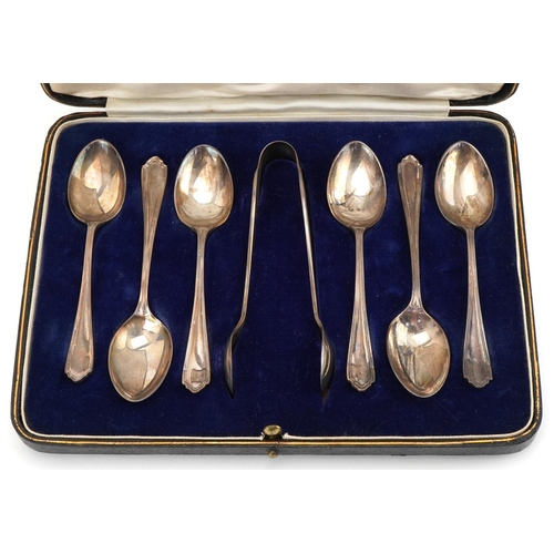 1346 - Henry Atkin, set of five George V silver teaspoons and sugar tongs housed in a velvet and silk lined... 