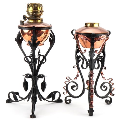 24 - Two Arts & Crafts copper and wrought iron oil lamps in the style of W.A.S Benson, 45cm high