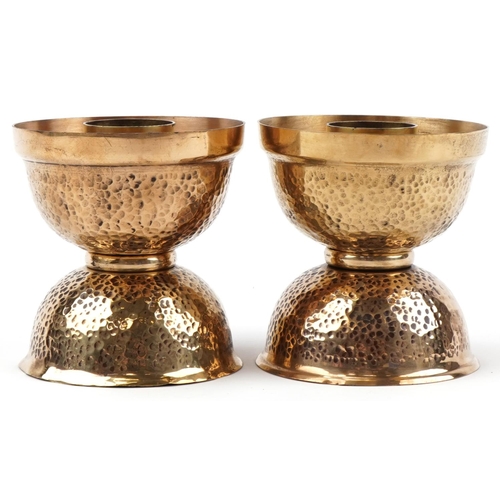 172 - Pair of Arts & Crafts brass candlesticks with hammered decoration,10cm high