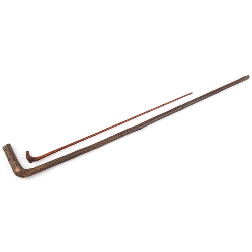 2308 - Two naturalistic wooden walking sticks, the largest 85cm in length