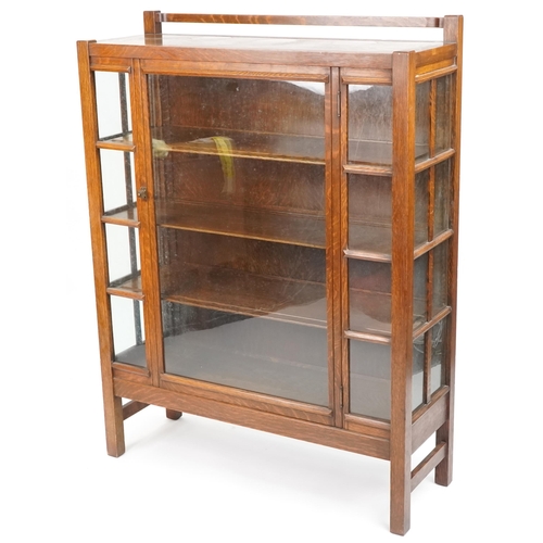 533 - George V Arts & Crafts oak display cabinet fitted with a glazed panel door, 145cm H x 109cm W x 39cm... 