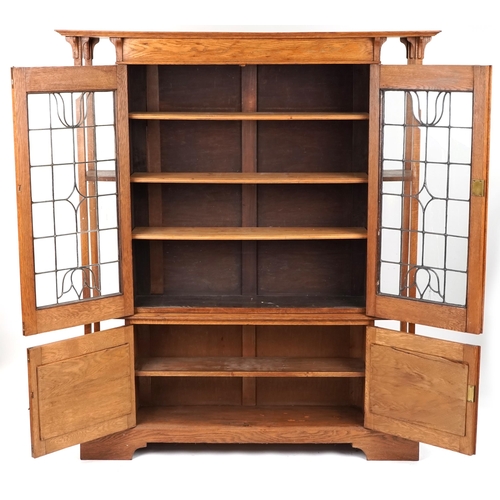 537 - Edwardian Arts & Crafts oak side cabinet with leaded glazed doors, 183cm H x 153cm W x 35cm D