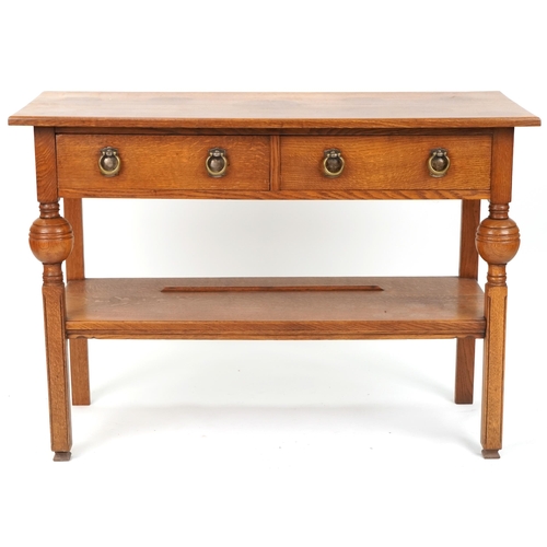 574 - 20th century Arts & Crafts style oak side table fitted with two drawers, 86cm H x 122cm W x 53cm D