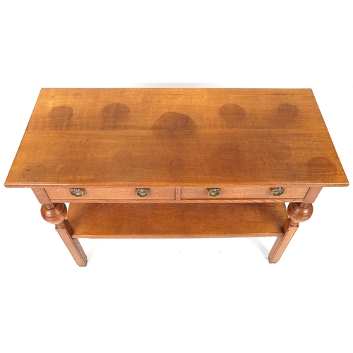 574 - 20th century Arts & Crafts style oak side table fitted with two drawers, 86cm H x 122cm W x 53cm D