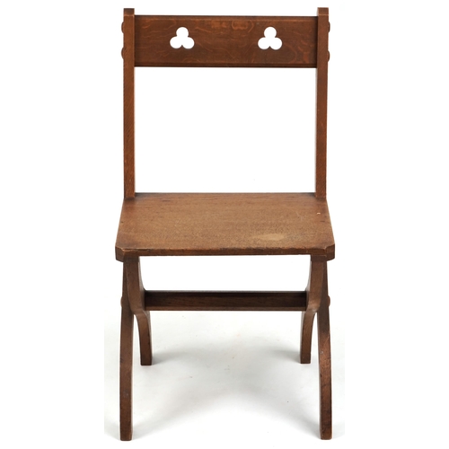 566 - Late Victorian Gothic Revival oak 'X' frame chair, 81cm H x 44cm W x 45cm D