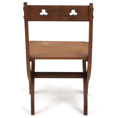 566 - Late Victorian Gothic Revival oak 'X' frame chair, 81cm H x 44cm W x 45cm D