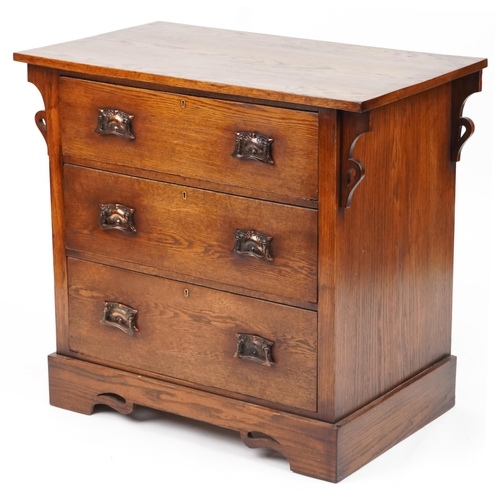 546 - George V Arts & Crafts oak chest of three long drawers with embossed copper handles, 84cm H x 91cm W... 