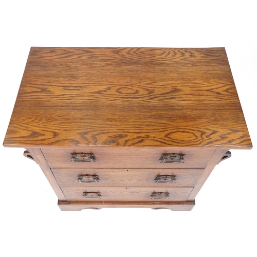 546 - George V Arts & Crafts oak chest of three long drawers with embossed copper handles, 84cm H x 91cm W... 