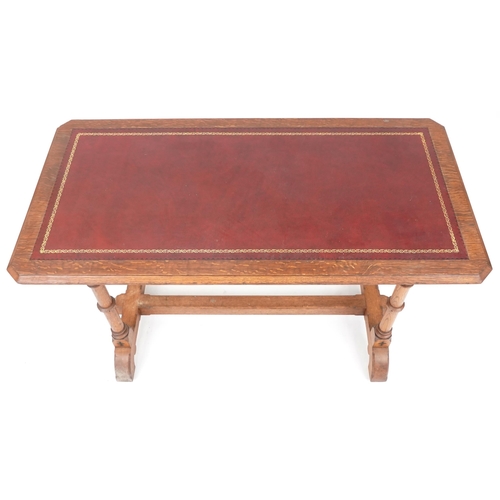 567 - Late Victorian Gothic Revival oak writing table, the top inset with a red gilt tooled leather writin... 