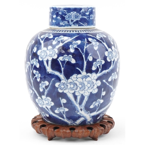 1257 - Large Chinese prunus pattern ginger jar and cover on carved wooden stand, 33cm high