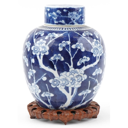 1257 - Large Chinese prunus pattern ginger jar and cover on carved wooden stand, 33cm high